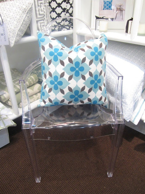 Nbaynadamas Coco's Flower Pillow on a Lucite chair at the New York International Gift Fair