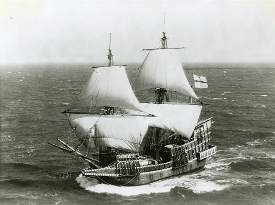 Stem view of the Golden Hinde (built 1973; galleon, replica) underway, circa 1970s. Black-and-white photographic print mounted on paper, 8 x 10 inches. The vessel is underway with full sail. Norgaard designed and oversaw the construction of this replica of the original GOLDEN HINDE, from 1971-1973.