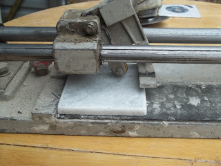 Tile Cutter Ready to Cut Piece of Ceramic Tile Tile Cutter Ready to Cut Piece of Ceramic Tile