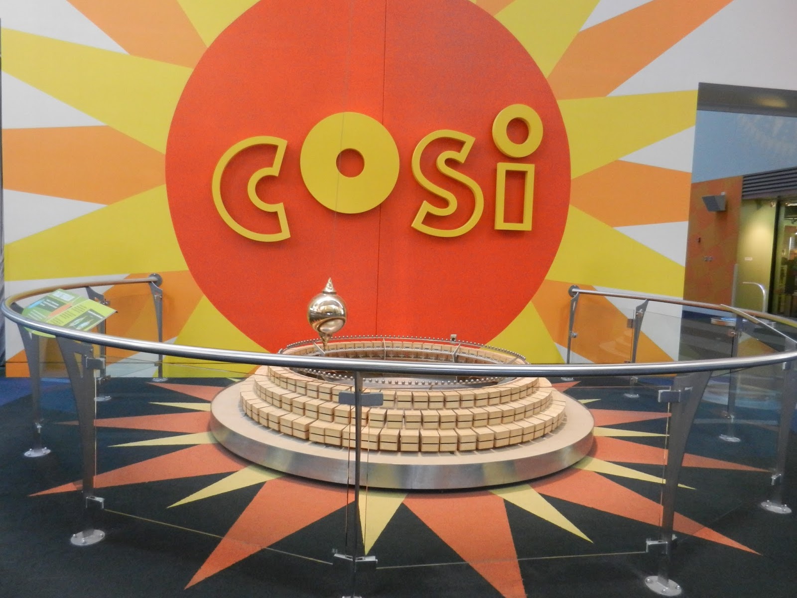 beauty of everyday life COSI stuck on the unicycle over the lobby