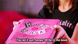No gif: As mãos de alguém entregando um livro rosa, em cima a leganda "Coloque pra fora, querido. Escreva no livro."
