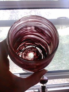 red paint swirled on inside of mason jar