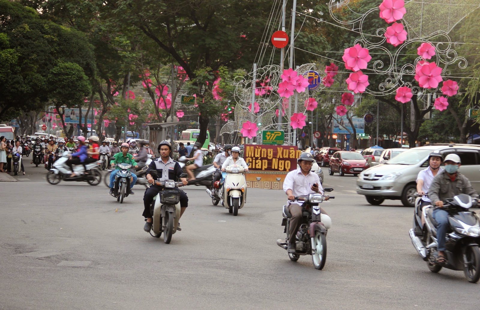 Welcome to Ho Chi Minh City-motorbike traffic and Tet holiday decorations. Welcome to Ho Chi Minh City-motorbike traffic and Tet holiday decorations.