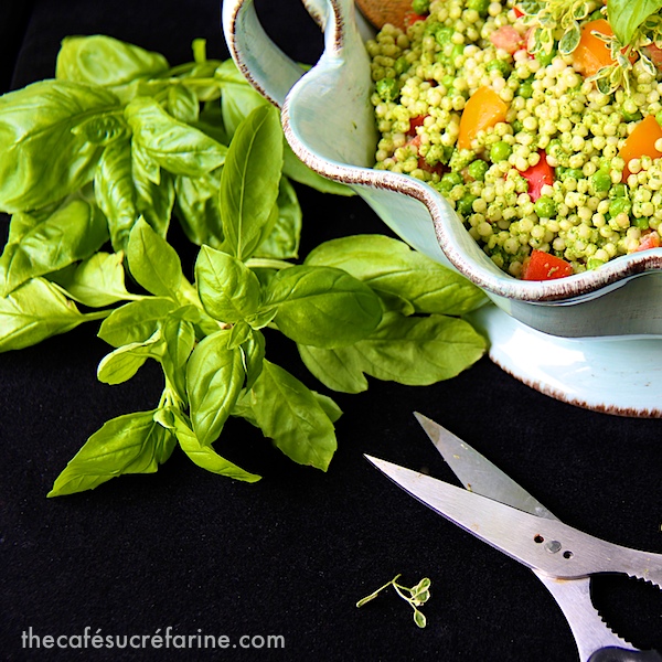 Israeli Couscous Salad with Heirloom Tomatoes - thecafesucrefarine.com Photo of a bowl of Israeli Couscous Salad with Heirloom Tomatoes with fresh basil leaves and a scissors next to the bowl.