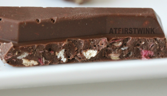 Tony's Chocolonely chocolate bar: milk chocolate with rhubarb and biscuit crumb close up