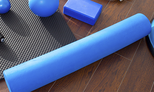 Foam roller workout accessories including a foam roller and yoga block. 