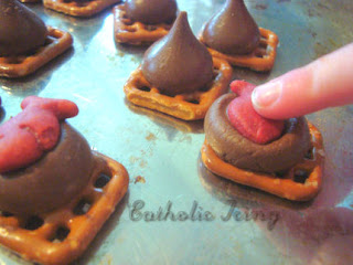 Melted Hershey's Kisses on Pretzel Squares with Goldfish