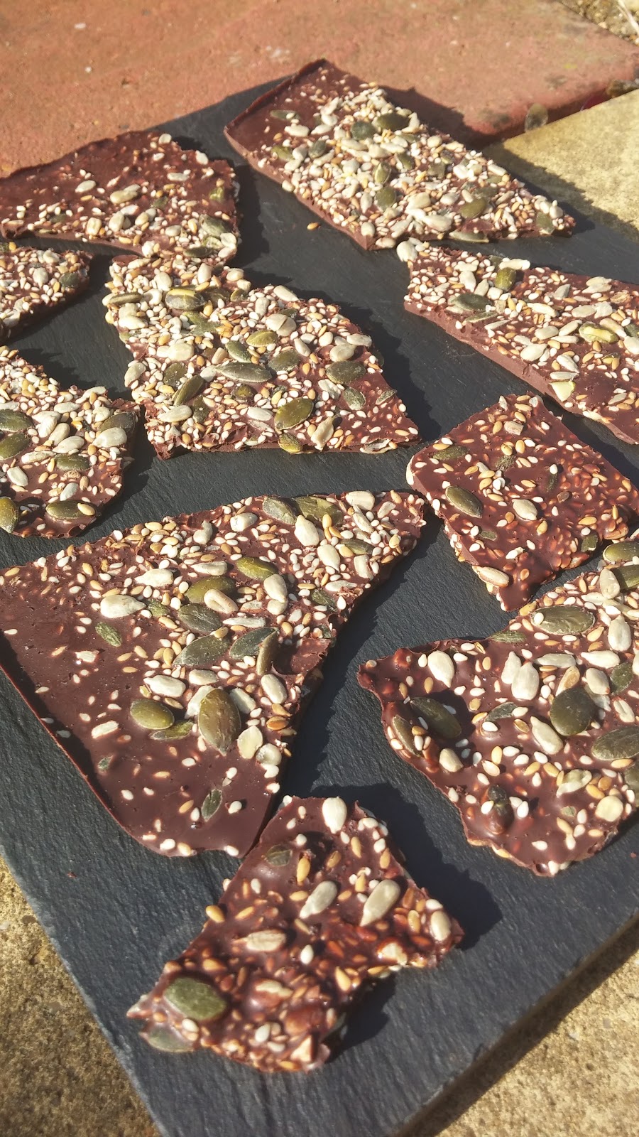 Thin pieces of dark chocolate enhanced with sea salt and mixed seeds