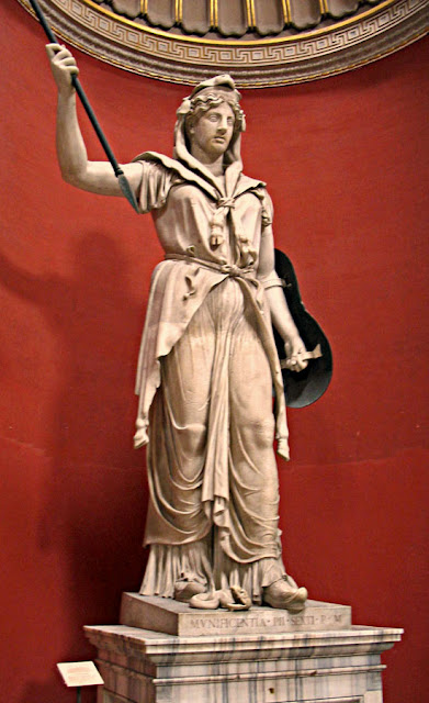 statue of a robed woman in armour  holding a spear at the Sistine chapel in Rome