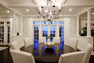 Black Round Dining Tables for Various Dining Room Designs Traditional White Chairs around the Round Dining Tables under Wide Iron Chandelier and the White Ceiling