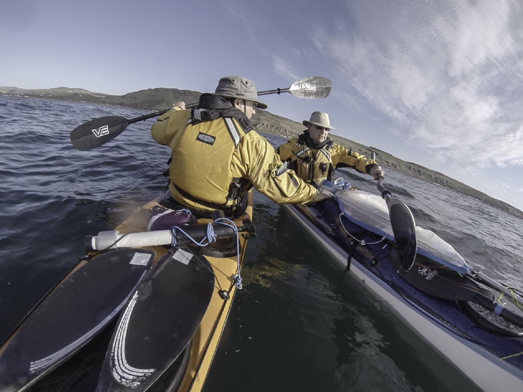 Sea kayaking with Assisted reentry after a capsize with a Flat Earth kayak sail.