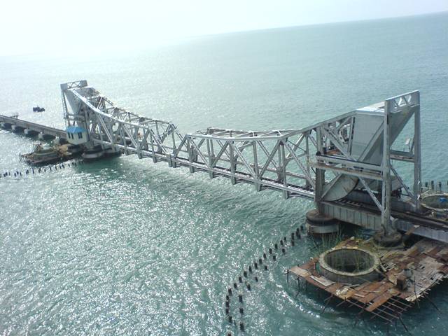 The Pamban Bridge  is a cantilever bridge on the Palk Strait connects Rameswaram on Pamban Island to mainland India. It refers to both the road bridge and the cantilever railway bridge, though primarily it means the latter. It was India's first sea bridge. It is the second longest sea bridge in India (after Bandra-Worli Sea Link) at a length of about 2.3 km. The rail bridge is for the most part, a conventional bridge resting on concrete piers, but has a double leaf bascule section midway, which can be raised to let ships and barges pass through.
