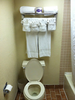 a bathroom with white towels on a rack