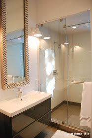 Ikea bathroom vanities in a modern bathroom with tall West Elm mirrors