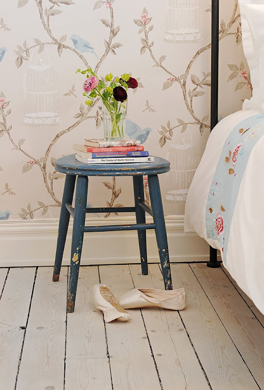 Close up of the blue stool doubling as a nightstand in a bedroom in a Swedish apartment