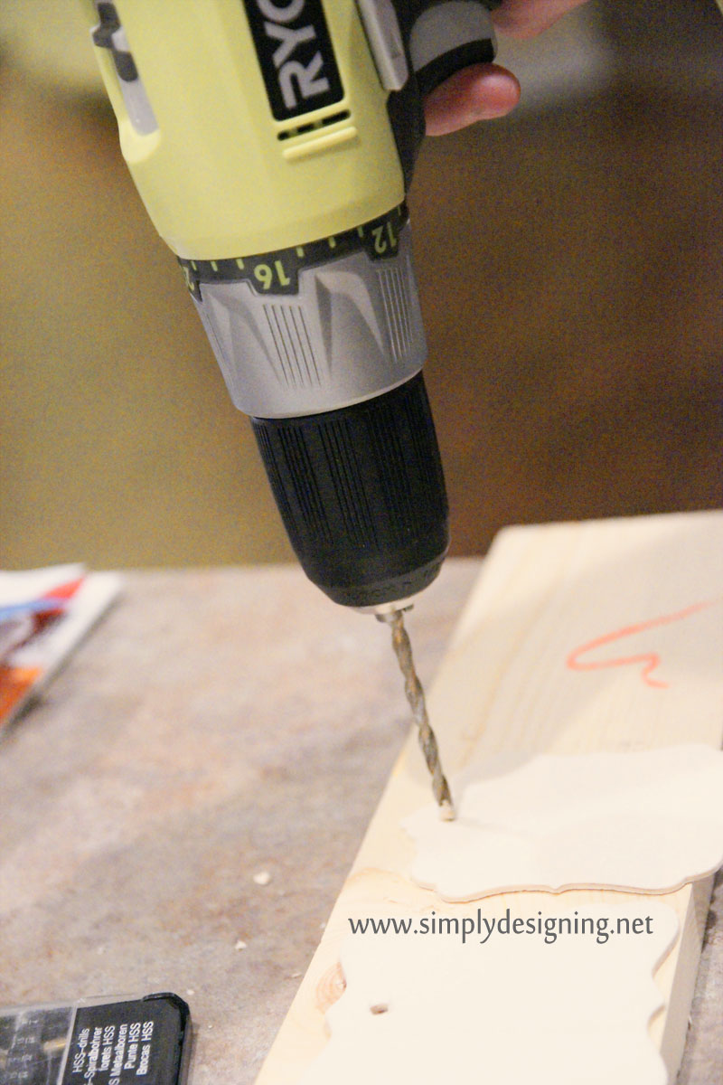 using a Ryobi drill to make a hole in a wooden tag