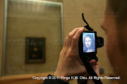 Tourists admire the famous Leonardo Da Vinci painting ' The Mona Lisa' in .