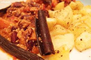 mexican chilli con carne with cinammon stick and fried potatos
