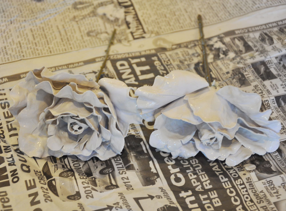 Step 3 Dip each flower in the plaster and coat the pedals. Shake off