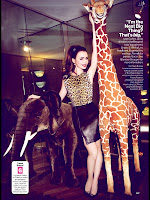 Lily Collins in leopard print outfit posing with stuffed animals