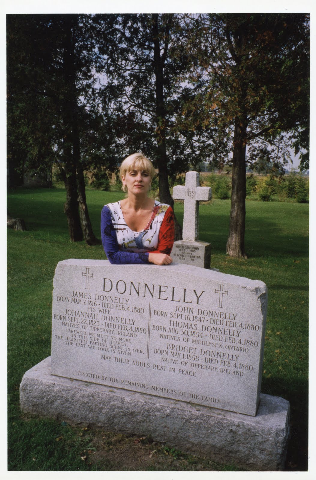 Blog author, Mary Jane Culbert at Donnelly gravesite near Lucan, Ontario (late 1990s)