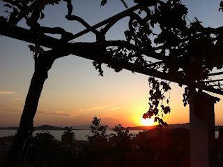 The sunset view of the surrounding islands from the balcony of the Taksiyarhis Pension.