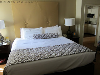 a bed with a white and black patterned blanket