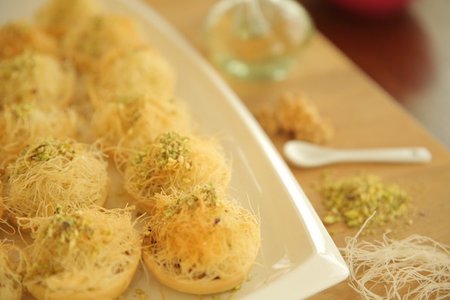 Knafeh Tart with nuts recipe Add orange blossom water while processing until the dough forms Knafeh Tart with nuts recipe