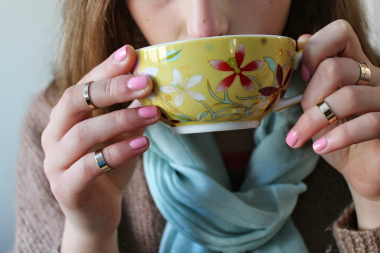 Caramel colored sweater, drinking tea with red lipstick