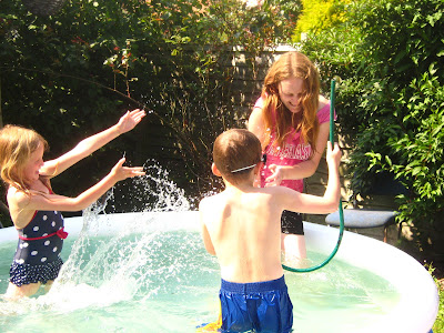 splashing in the paddeling pool family fun outdoors