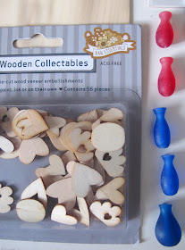 A packet of wooden cutouts in the shape of hearts and clouds and five plastic vase-shaped pieces.