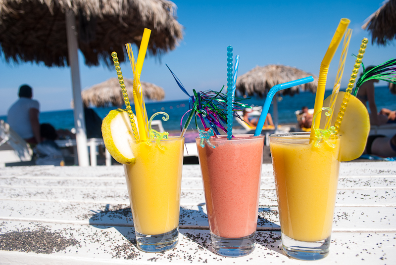 cocktail smoothies on the black beach of perisssa cocktails and enjoying the beach in santorini, greece