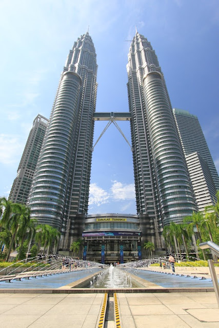 Another full view of Petronas Twin Towers near the fountain in Kuala Lumpur, Malaysia Another full view of Petronas Twin Towers near the fountain in Kuala Lumpur, Malaysia
