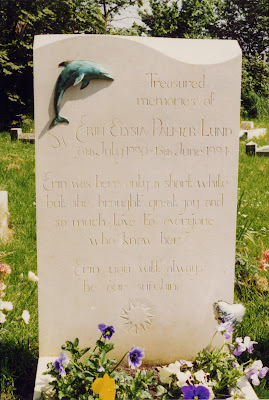 Portland limestone headstone with shaped top bronze dolphin