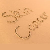 "Skin Cancer" written in sand