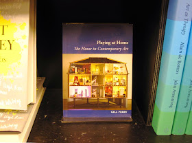 The book 'The house as contemporary art' on display in a shop.