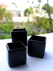 Three different-sized square black modern dolls' house miniature plant pots.