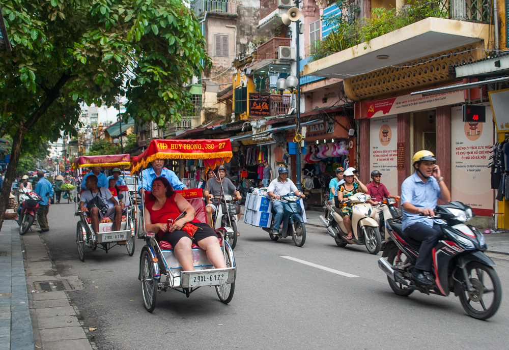 Trishaw riding motorcycles and trishaws in hanoi