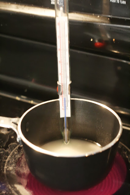 Sugar and water in a heavy bottomed pot. Candy thermometer on the side to measure the temperature.