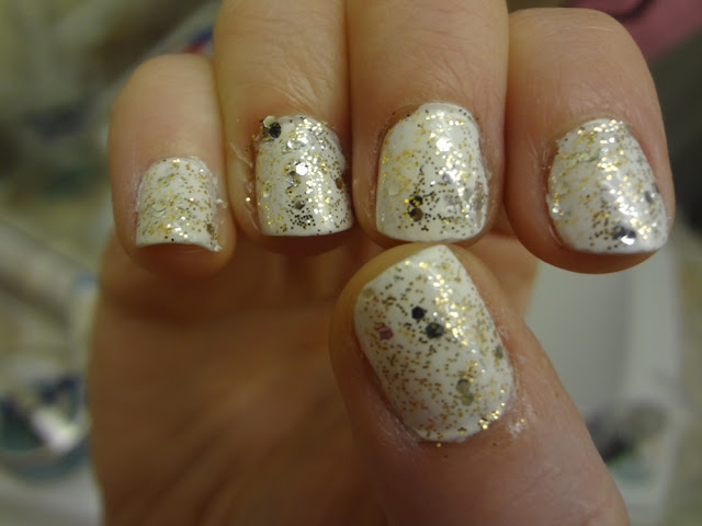 white nail polish with gold and silver glitter