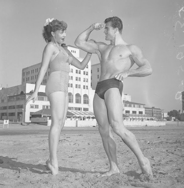 coney island, brooklyn, new york vintage photo of pinup and muscleman on the beach