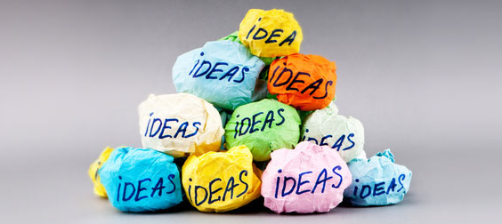 Photo of a stack of crumpled up balls of different colored paper, each ball labeled "IDEA"