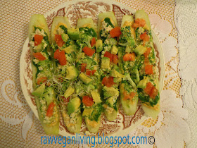 raw vegan pizza with spinach pesto, cheese and other toppings