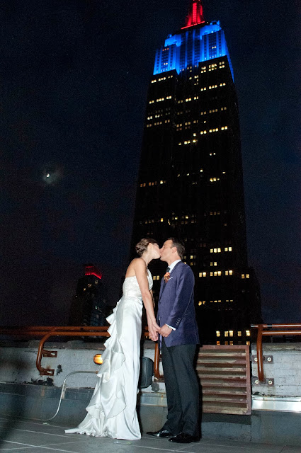 Rooftop Kiss with moon and Empire State Building lit up 