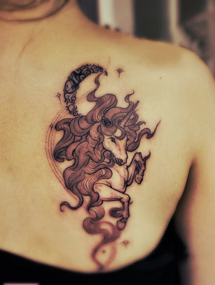 unicorn and crescent moon tattoo on the back