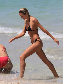 Candice Swanepoel exits the water at Miami Beach