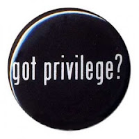Illustration of a black button with "got privilege?" in white letters