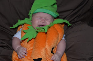 Baby in a pumpkin costume 