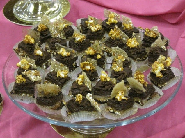 a plate of choclate brownies topped with gold nuts at the chocolate dreams fundraiser