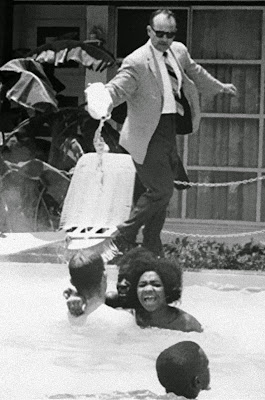 The manager of the motel, James Brock was photographed pouring muriatic acid into the pool to get the protesters out.